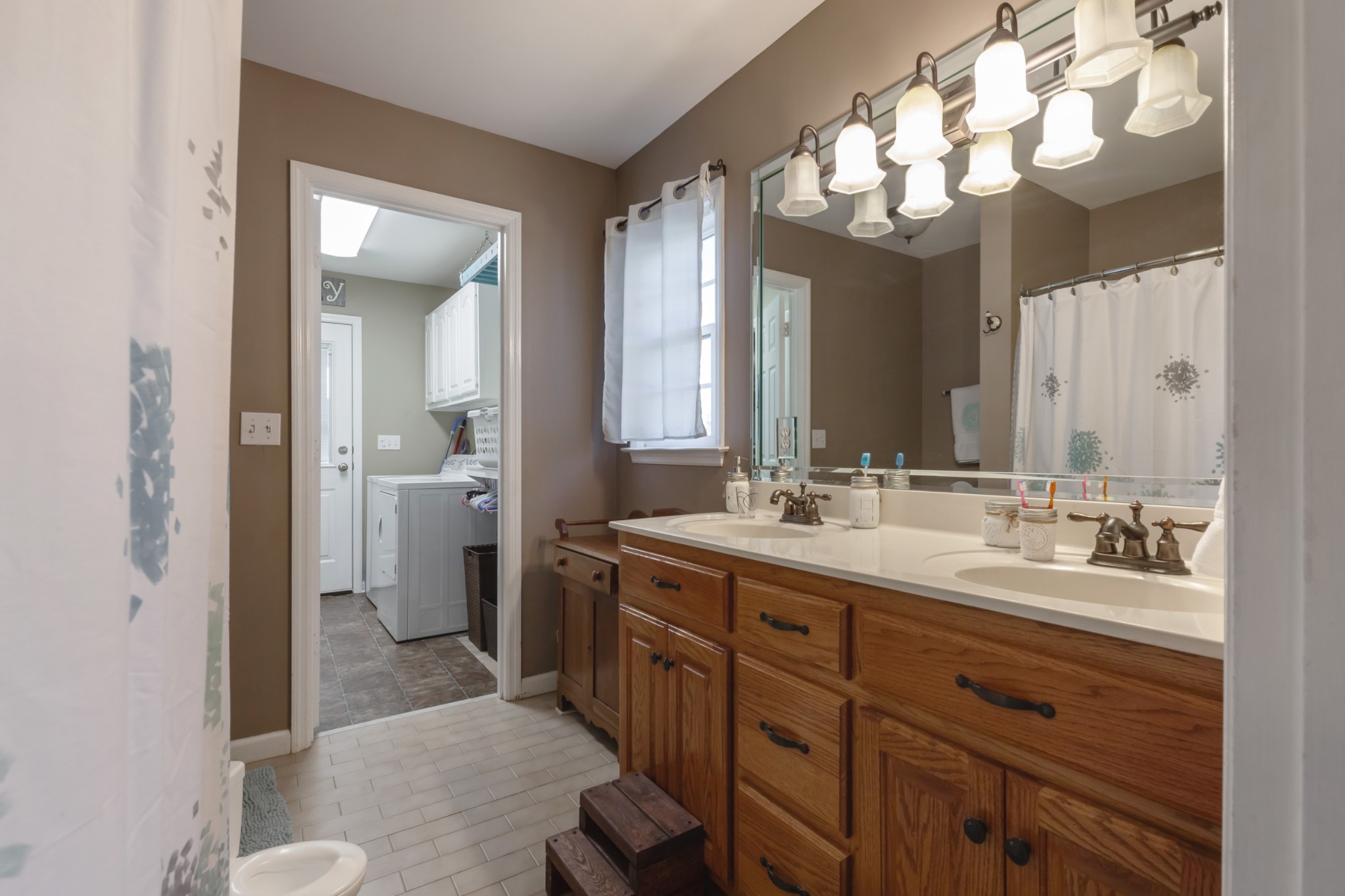 7055 Buford Station Road Lynnville, TN 38472 - Photo 19 of 34 a spacious bathroom with a double vanity sink mirror and toilet