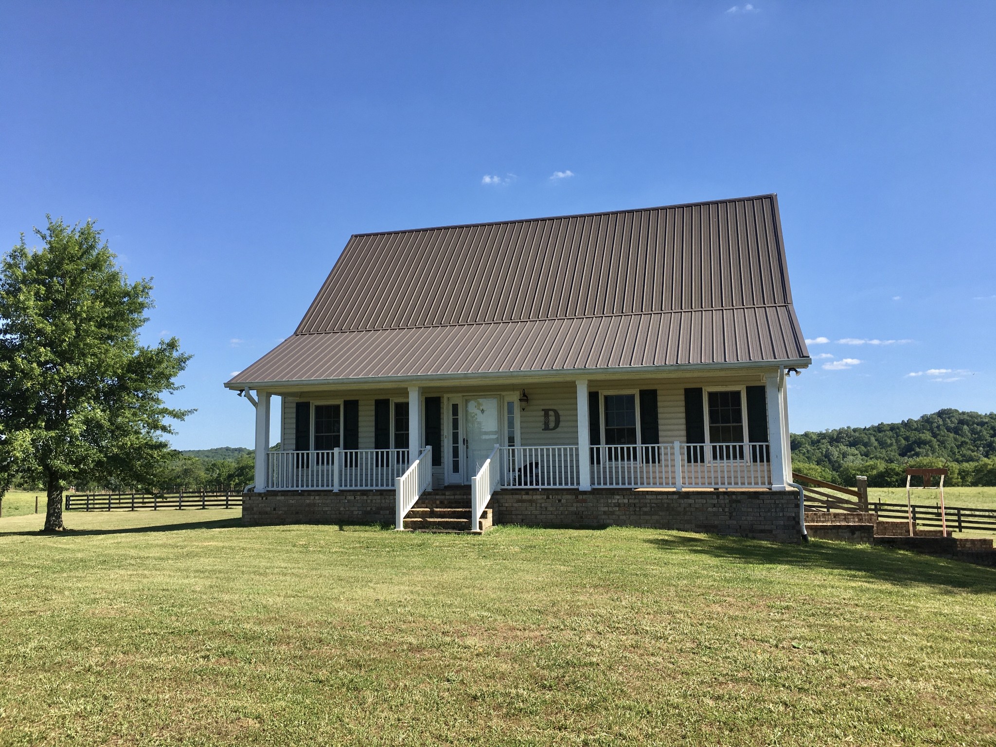 7055 Buford Station Road Lynnville, TN 38472 - Photo 26 of 34 a front view of a house with a garden