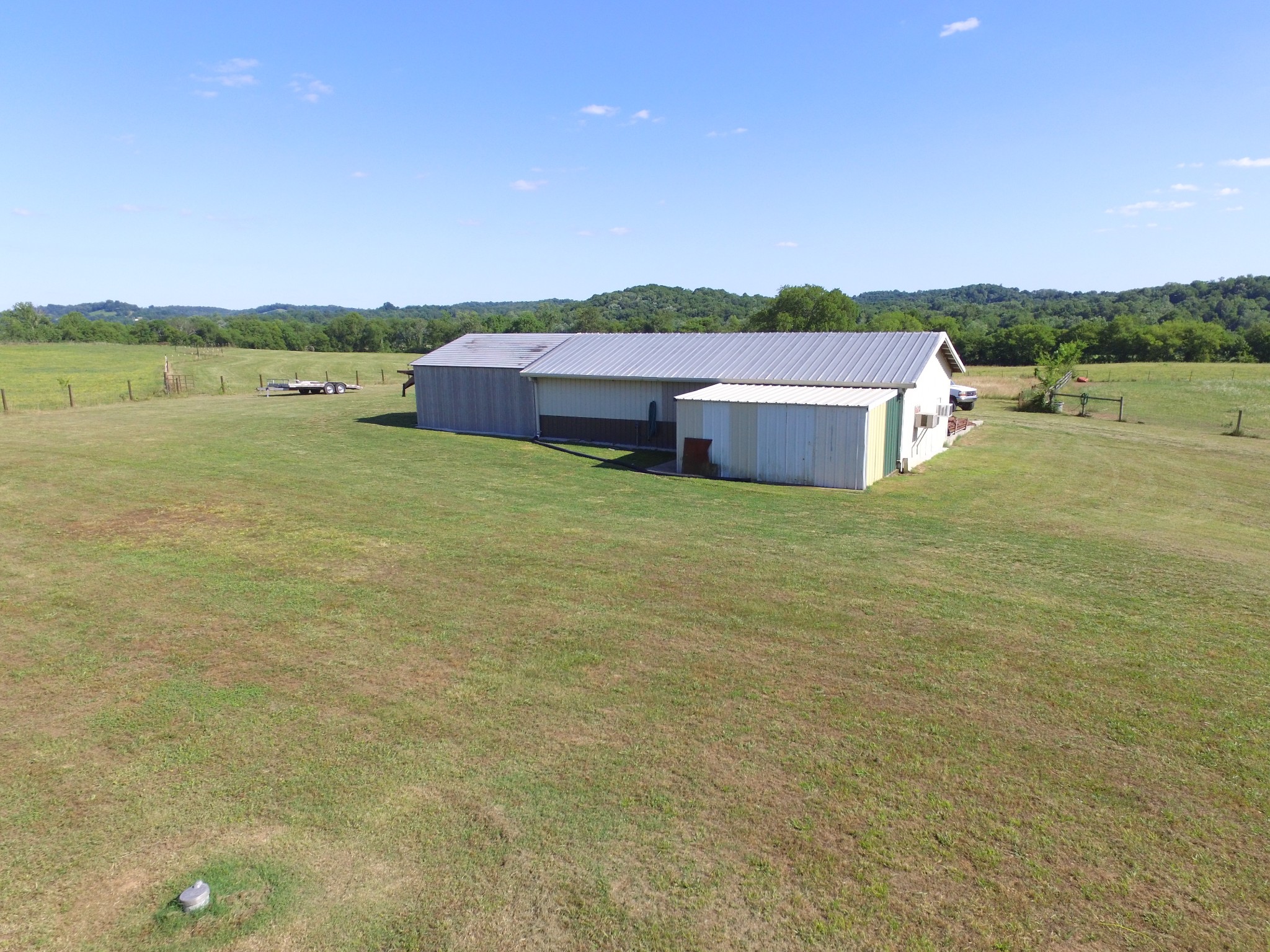 7055 Buford Station Road Lynnville, TN 38472 - Photo 31 of 34 a backyard of a house with a yard and palm trees