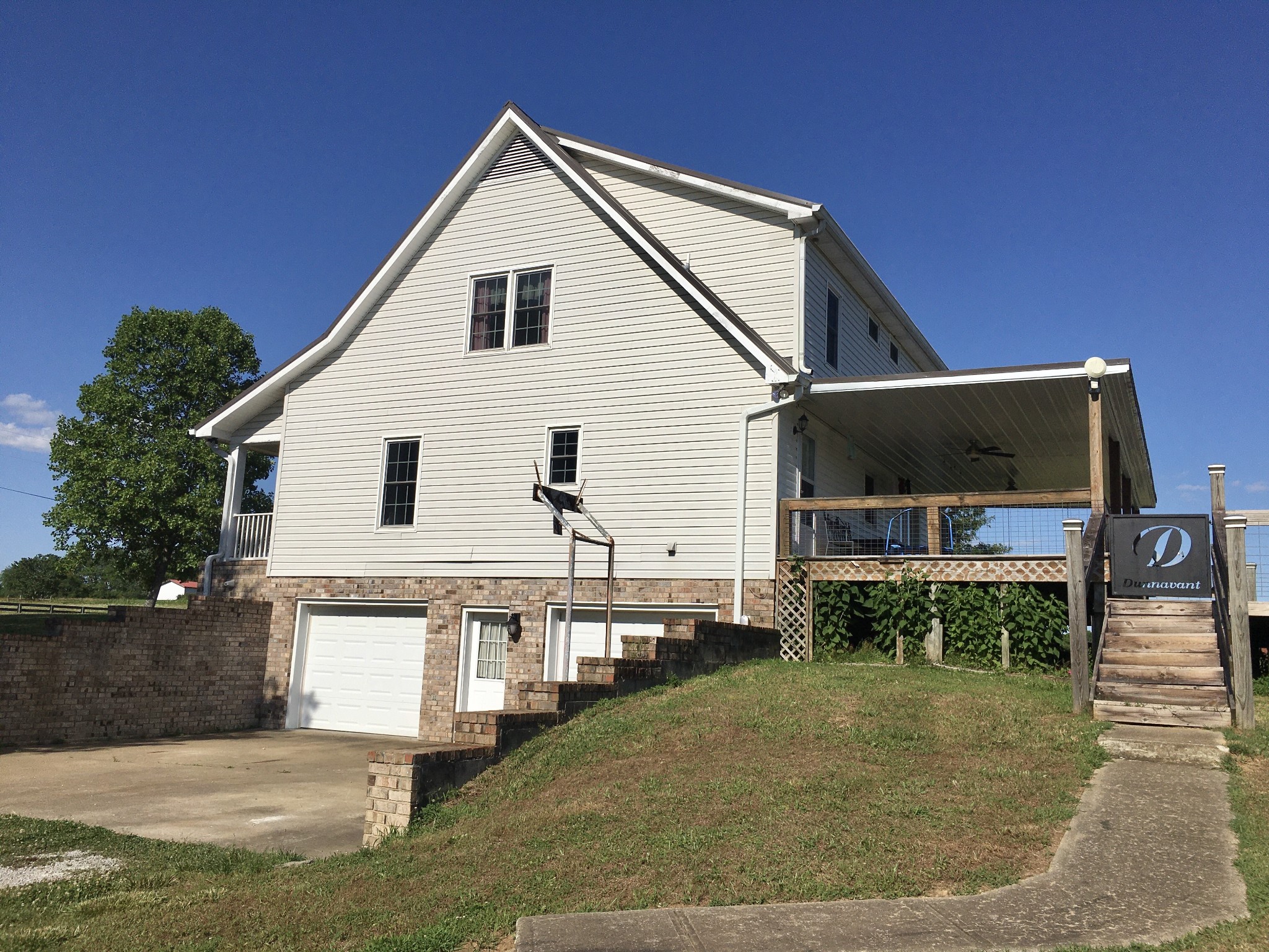 7055 Buford Station Road Lynnville, TN 38472 - Photo 6 of 34 a view of a white house with a yard and plants