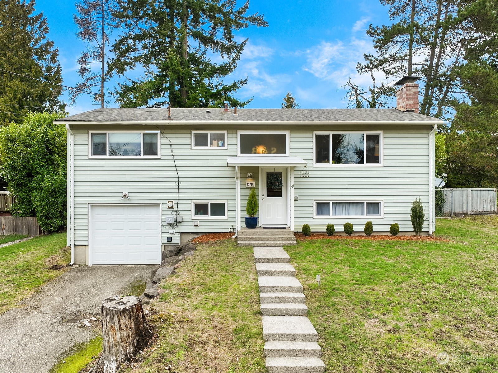 12728 Southeast 163rd Street Renton, WA 98058 - Photo 1 of 40 a front view of a house with a yard