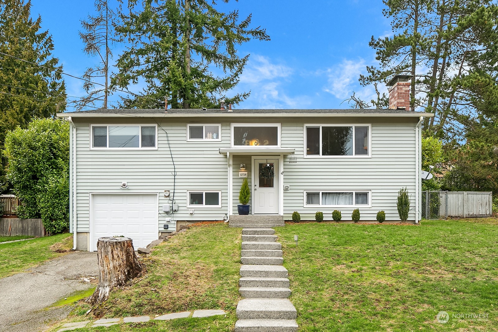 12728 Southeast 163rd Street Renton, WA 98058 - Photo 39 of 40 a front view of a house with a yard