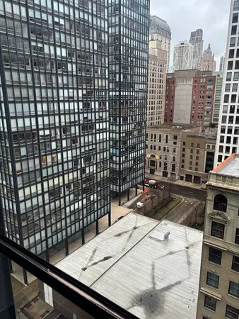 a view of a balcony with a barbeque