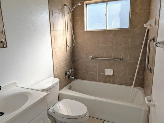 a white bath tub sitting next to a white toilet