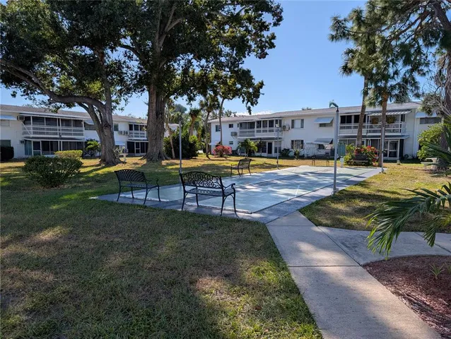 a view of a house with swimming pool and sitting area