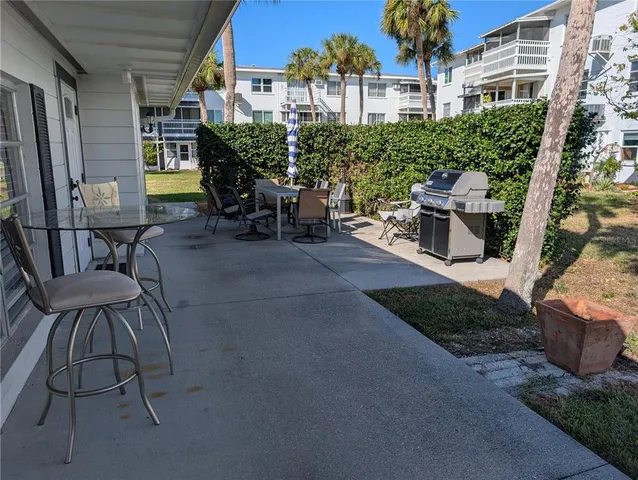 a view of a patio with table and chairs and potted plants