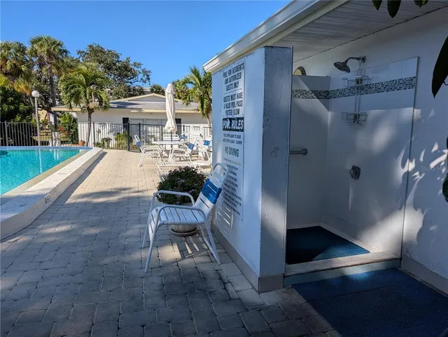 a view of a porch with chairs and potted plants