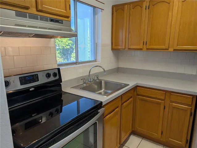 a kitchen with a sink cabinets and window