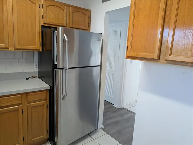 a white refrigerator freezer and a stove sitting inside of a kitchen