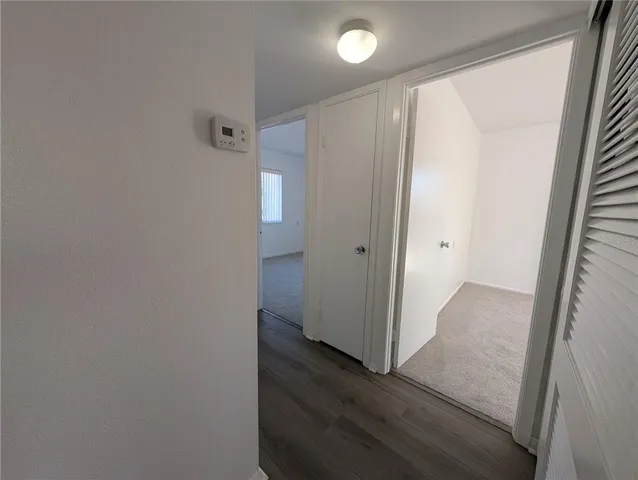 a view of hallway with wooden floor