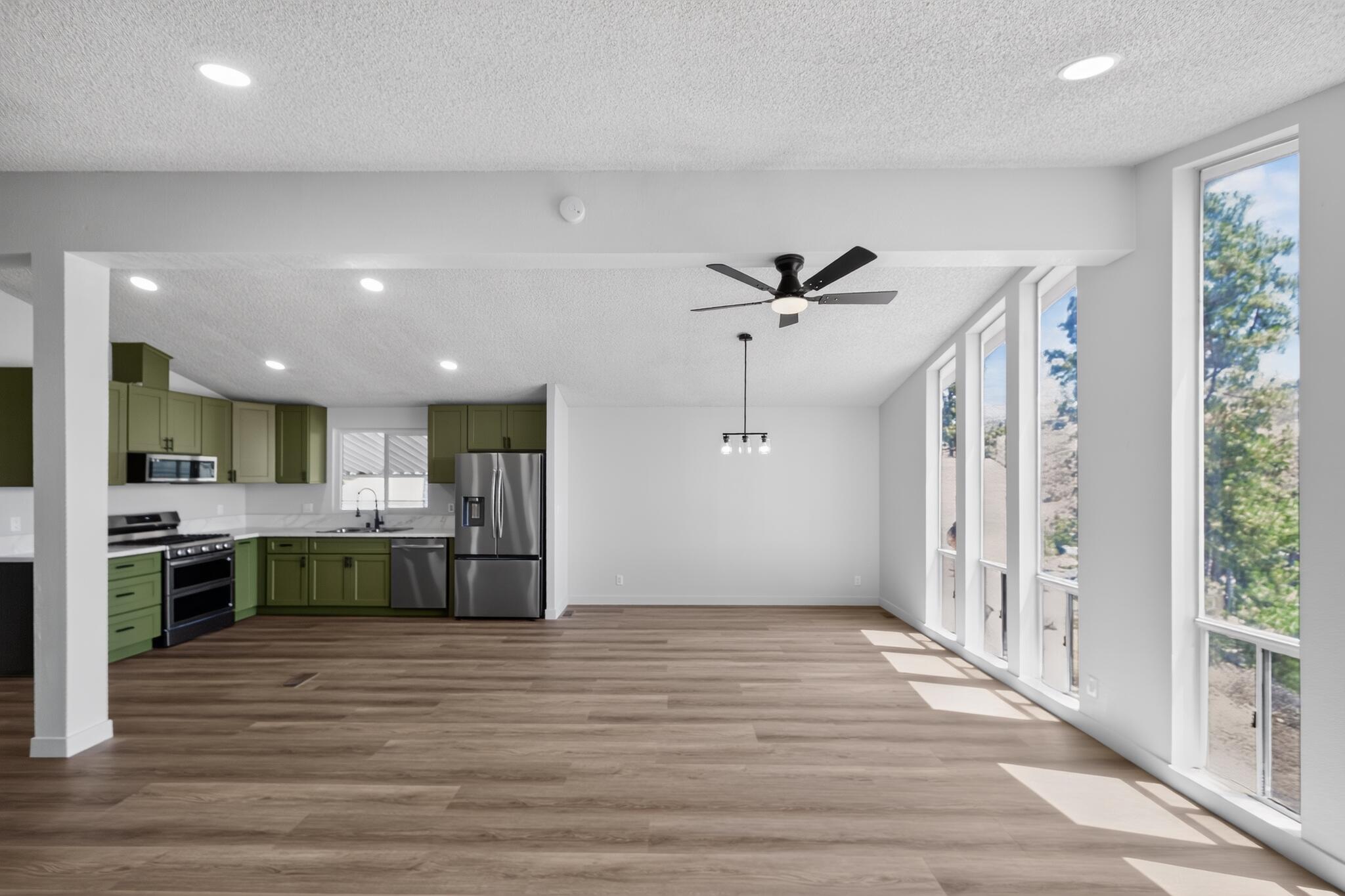 15181 Van Buren Boulevard, Unit 102 Riverside, CA 92504 - Photo 9 of 29 a view of kitchen with kitchen island wooden floor center island stainless steel appliances and cabinets