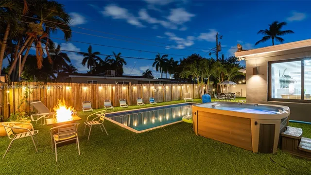 a view of a swimming pool with outdoor seating