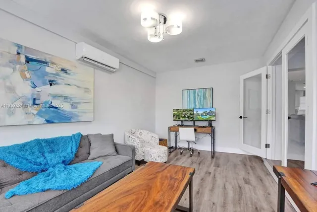 a bedroom with a bed and a potted plant