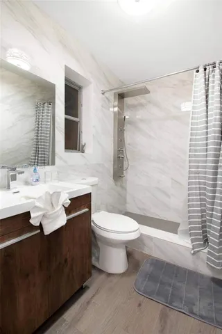 a bathroom with a sink a toilet and bathtub