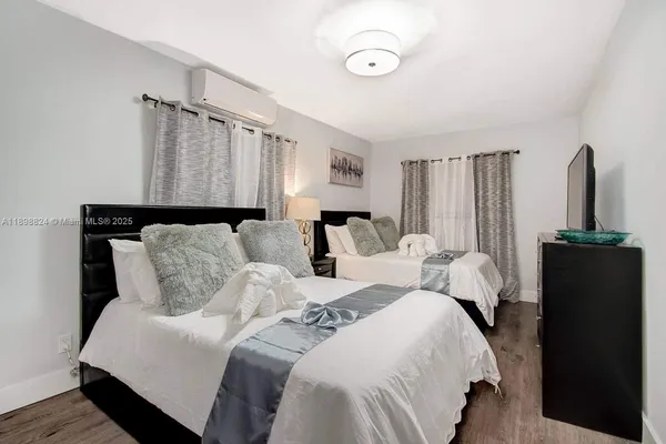 a bedroom with a bed and a flat screen tv