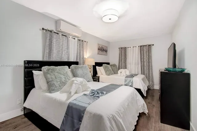 a bedroom with a bed and a flat screen tv