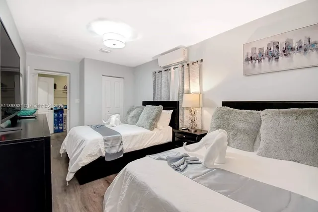 a bedroom with a bed and a television