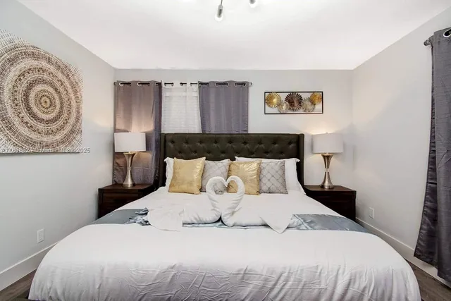 a bedroom with bed and a chandelier