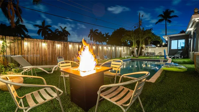 a view of a swimming pool with an outdoor seating