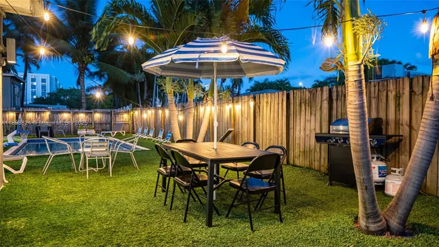 a view of a patio with table and chairs and potted plants