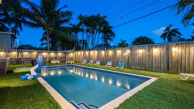 a view of a chair and table in backyard of the house