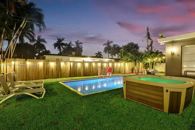 a view of a house with a yard and deck