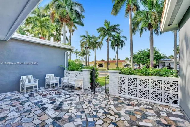 an aerial view of a house with garden space and street view