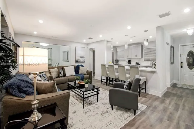 a living room with furniture potted plant and a window
