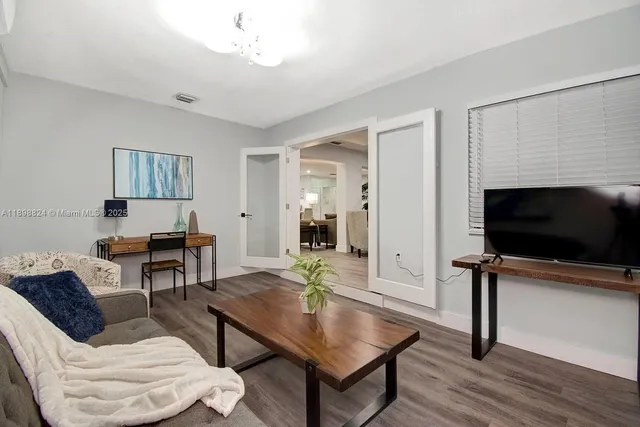 a living room with furniture and a flat screen tv