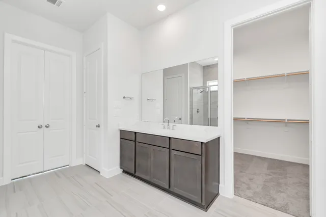 a bathroom with a bathtub shower sink and mirror