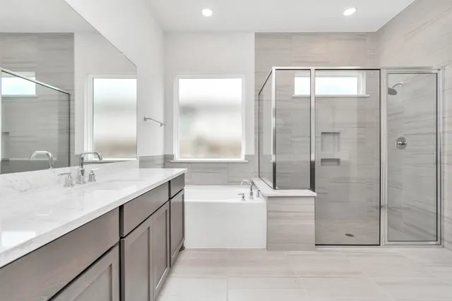 a bathroom with a double vanity sink a mirror and a shower