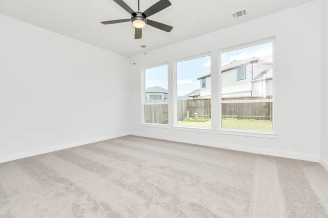 a view of a kitchen with granite countertop a sink and a large window