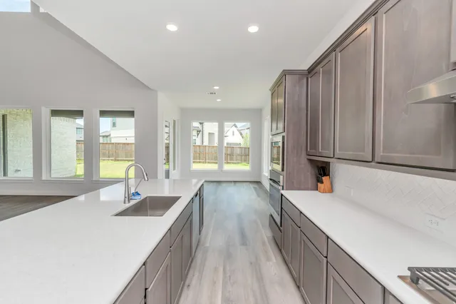 a view of a living room with kitchen island furniture and a kitchen view
