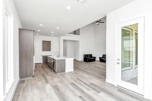 a view of living room with granite countertop furniture and wooden floor