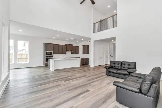 a living room with furniture and a hard wood floor