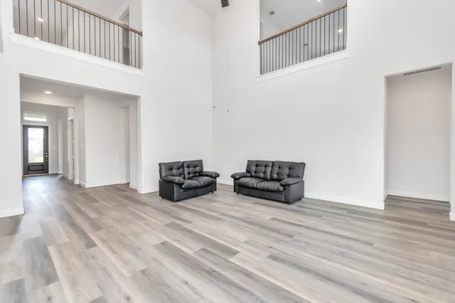a view of a hallway with wooden floor and entryway