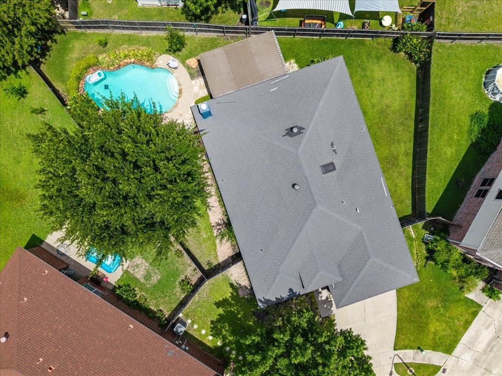 3413 Westfork Ranch Road Fort Worth, TX 76262 - Photo 31 of 35 Expansive backyard featuring a freeform swimming pool with integrated steps, surrounded by flagstone paving