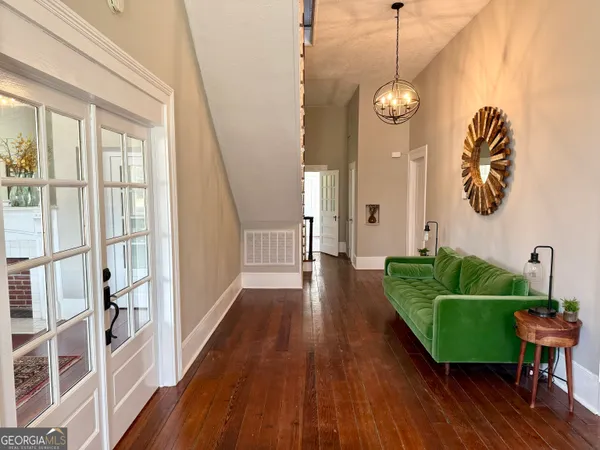 a living room with furniture and a wooden floor