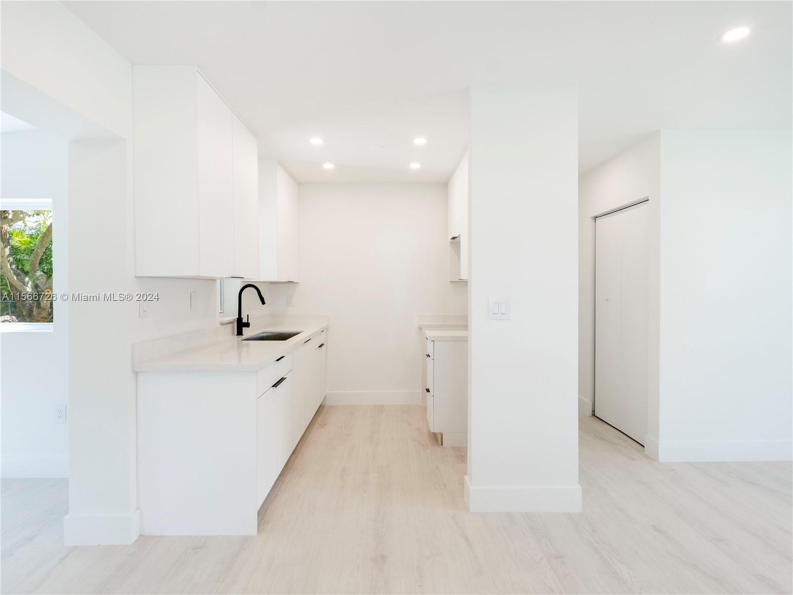 11561 Southwest 187th Street Miami, FL 33157 - Photo 12 of 35 a view of a bathroom with a sink and mirror