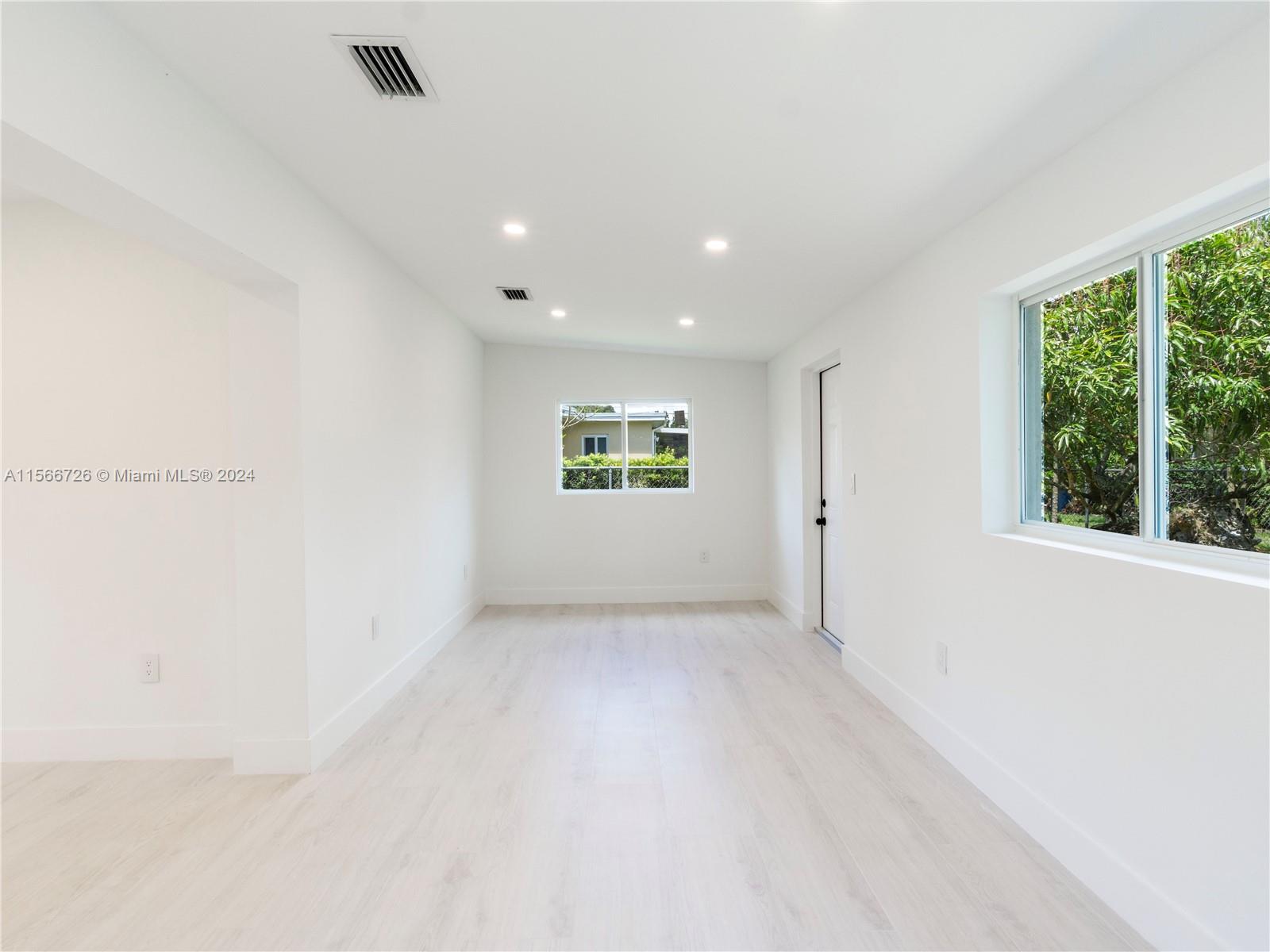 11561 Southwest 187th Street Miami, FL 33157 - Photo 13 of 35 an empty room with windows
