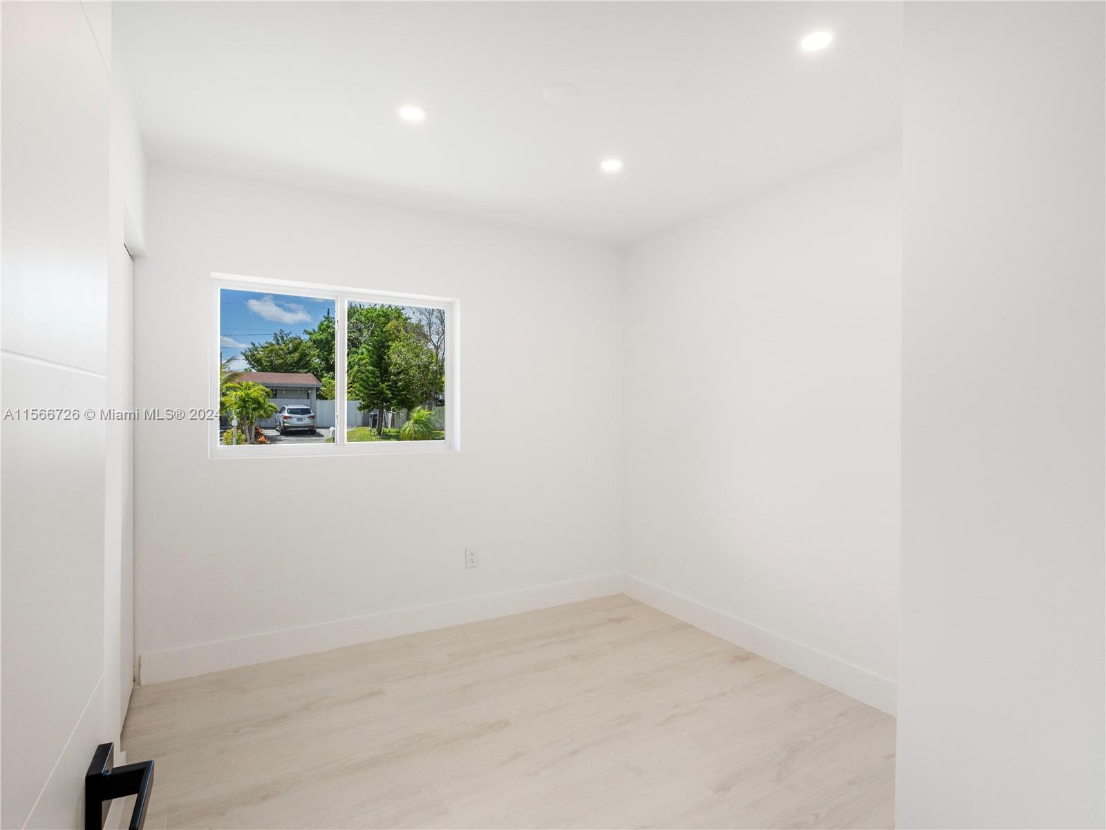 11561 Southwest 187th Street Miami, FL 33157 - Photo 17 of 35 an empty room with windows