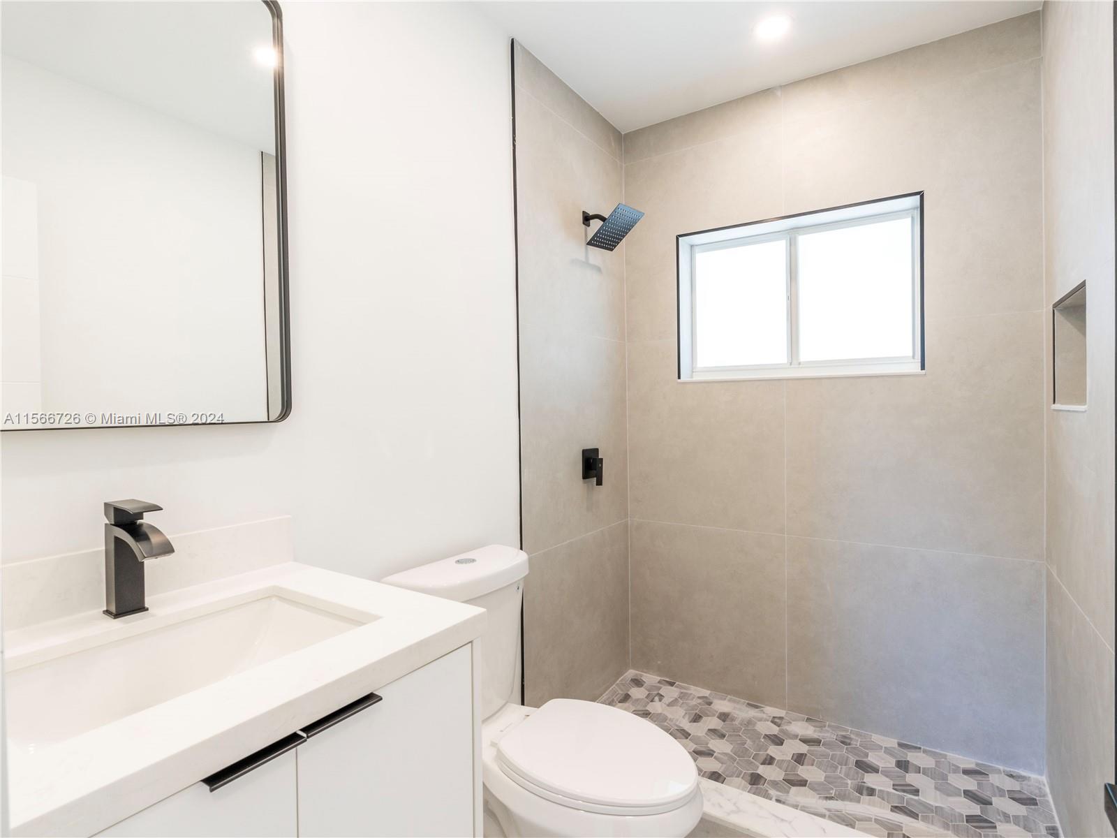 11561 Southwest 187th Street Miami, FL 33157 - Photo 19 of 35 a bathroom with a sink a toilet and shower