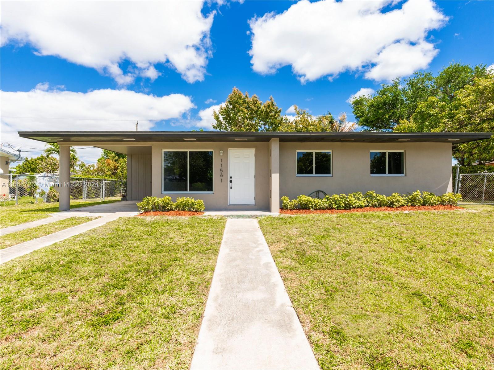 11561 Southwest 187th Street Miami, FL 33157 - Photo 2 of 35 a front view of house with yard and outdoor seating