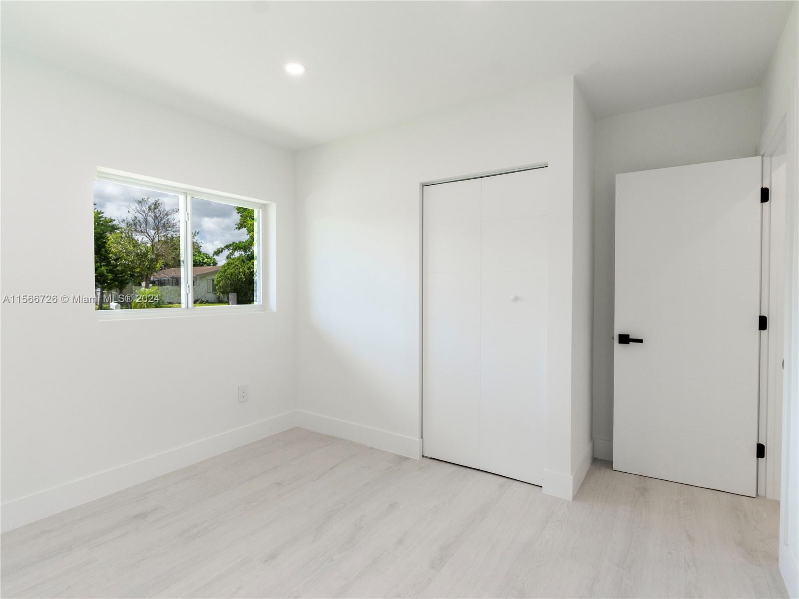 11561 Southwest 187th Street Miami, FL 33157 - Photo 21 of 35 an empty room with windows