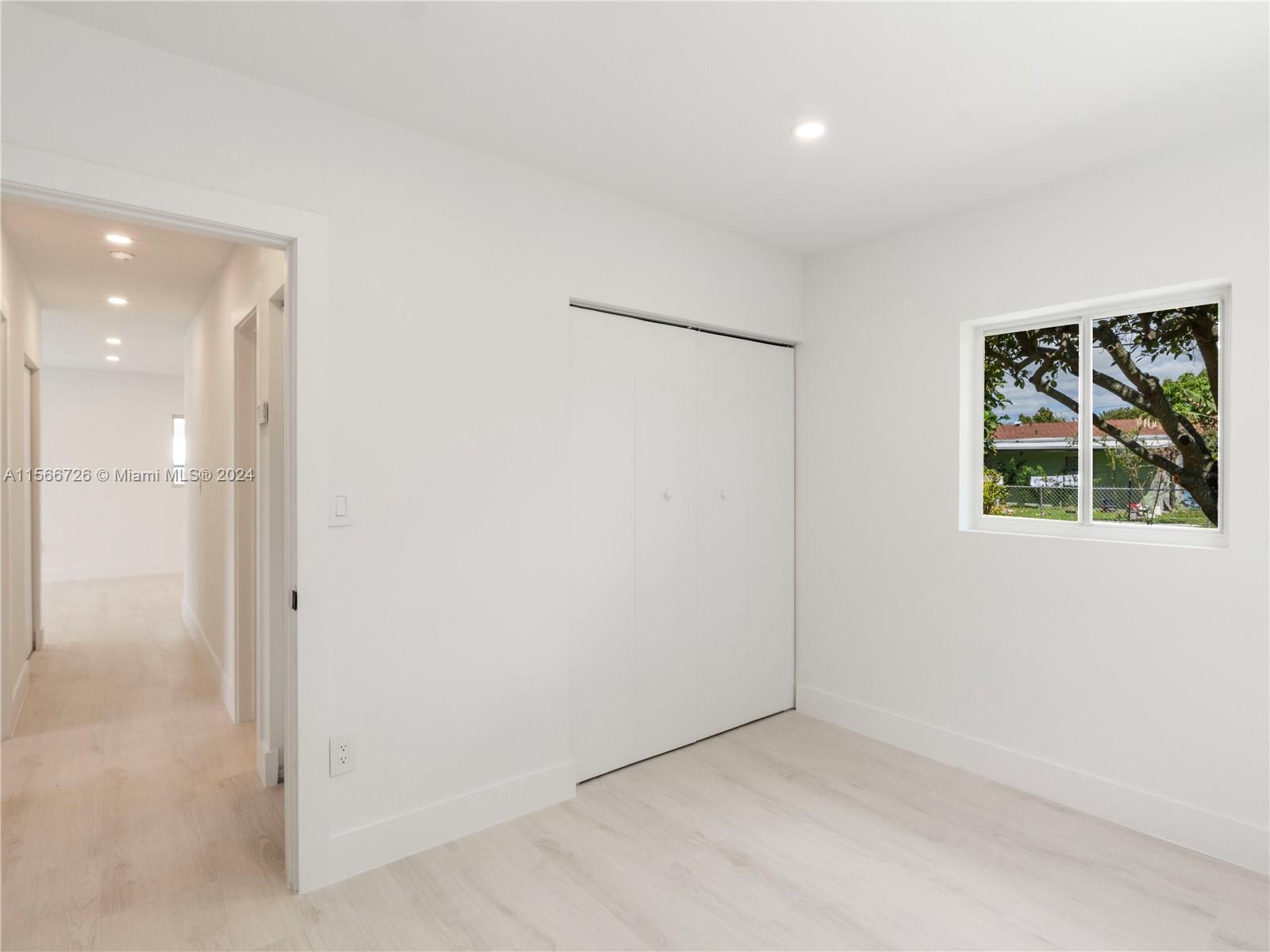 11561 Southwest 187th Street Miami, FL 33157 - Photo 23 of 35 an empty room with windows and closet