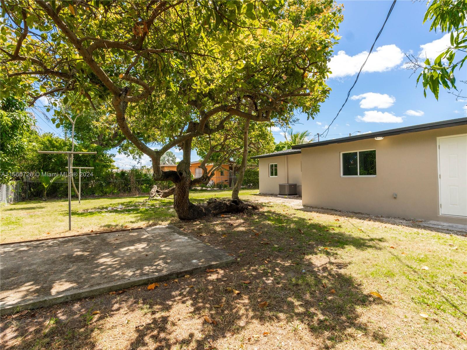 11561 Southwest 187th Street Miami, FL 33157 - Photo 28 of 35 a view of a house with a backyard