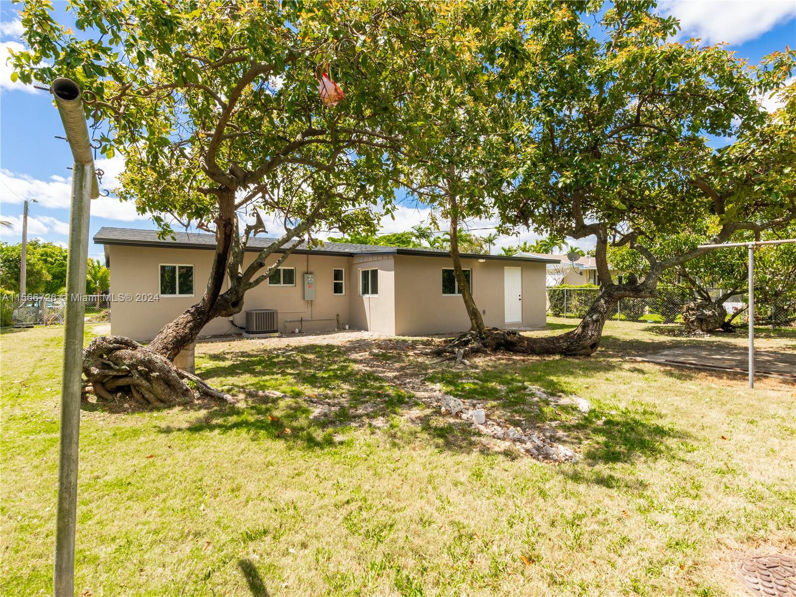 11561 Southwest 187th Street Miami, FL 33157 - Photo 30 of 35 a view of a house with a yard