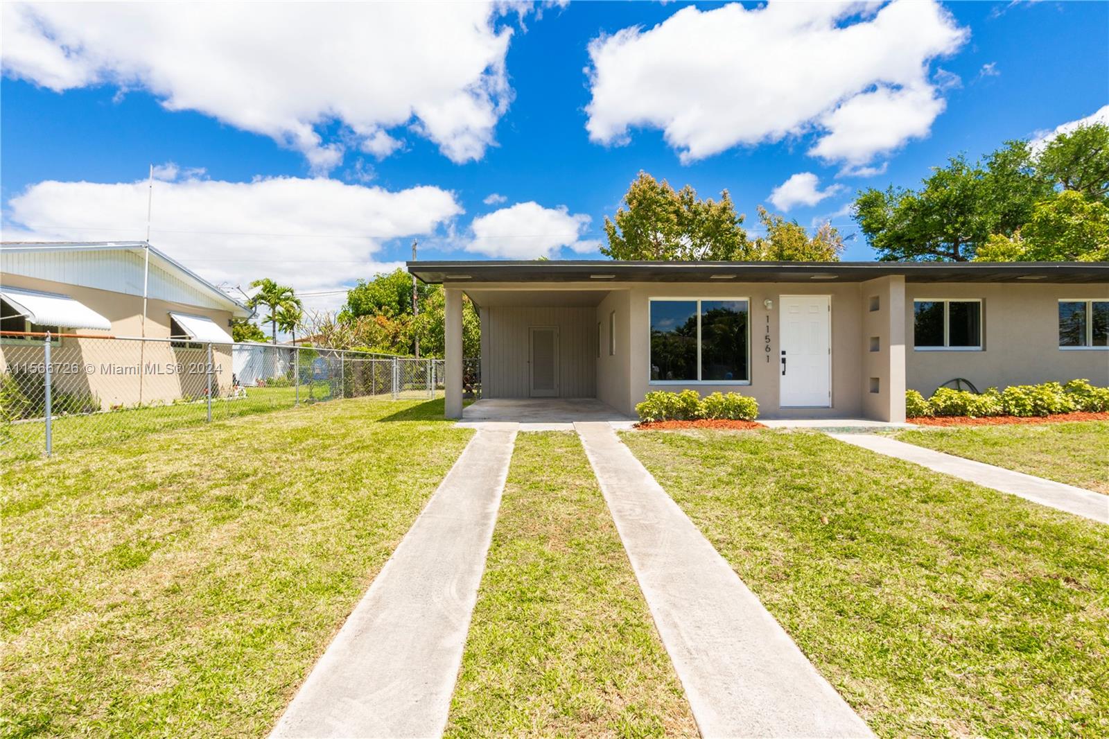 11561 Southwest 187th Street Miami, FL 33157 - Photo 5 of 35 a house view with swimming pool and garden