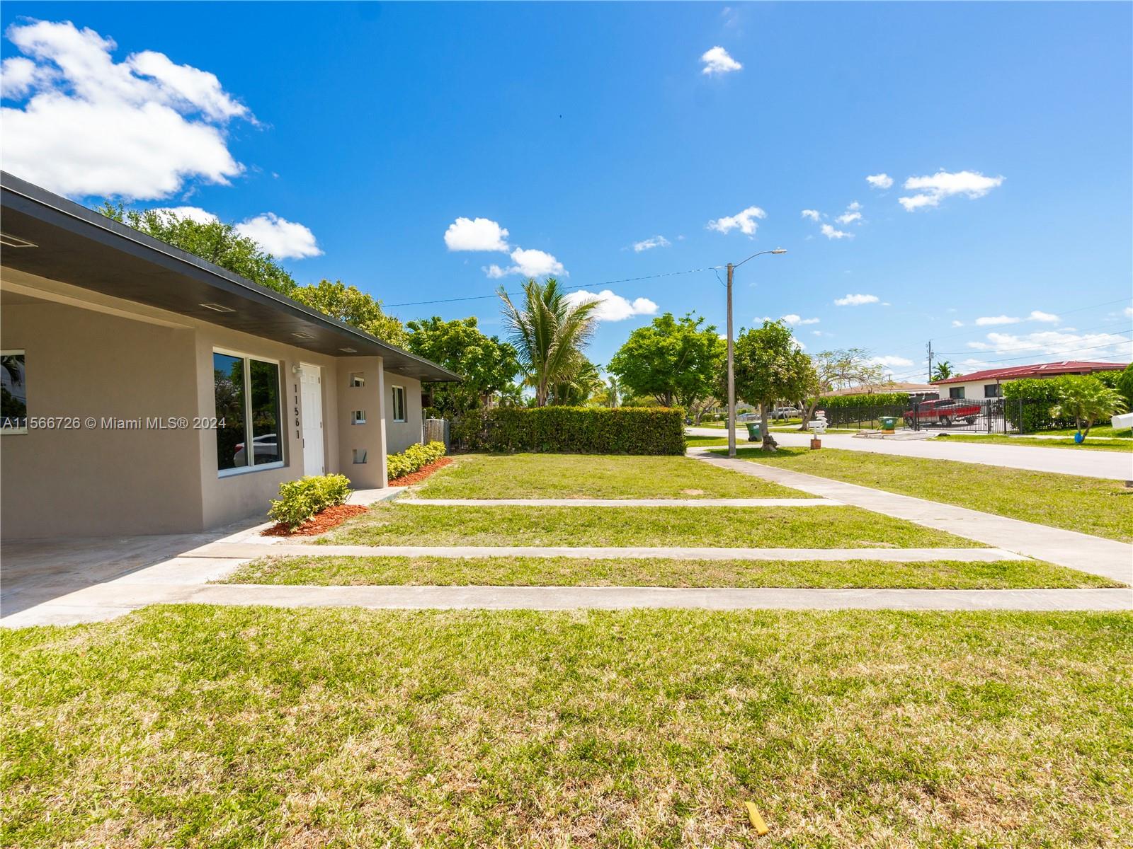 11561 Southwest 187th Street Miami, FL 33157 - Photo 7 of 35 a view of a swimming pool with an outdoor space and seating area