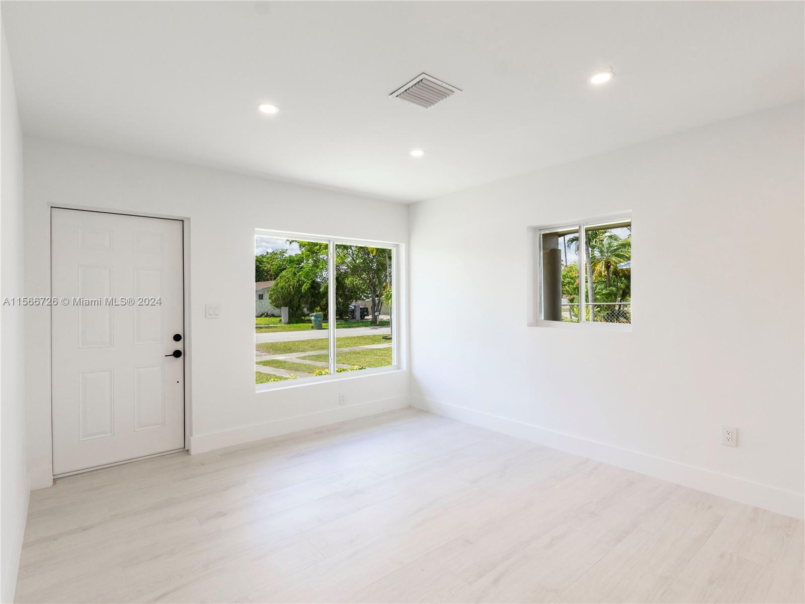 11561 Southwest 187th Street Miami, FL 33157 - Photo 9 of 35 an empty room with windows